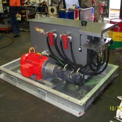 Industrial hydraulic power unit with red motor and gray metal tank